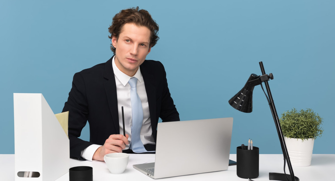 Man working on computer doing Payroll Outsourcing