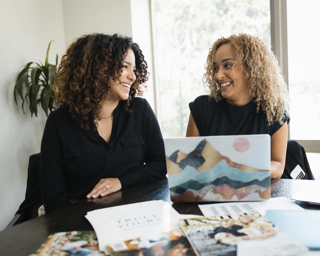 2 woman working in financial office with laptop