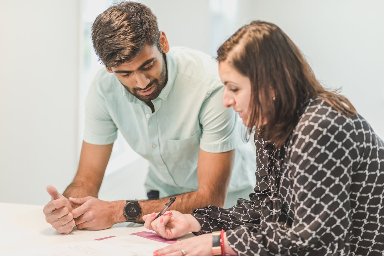 Man and Woman Looking at the Documents